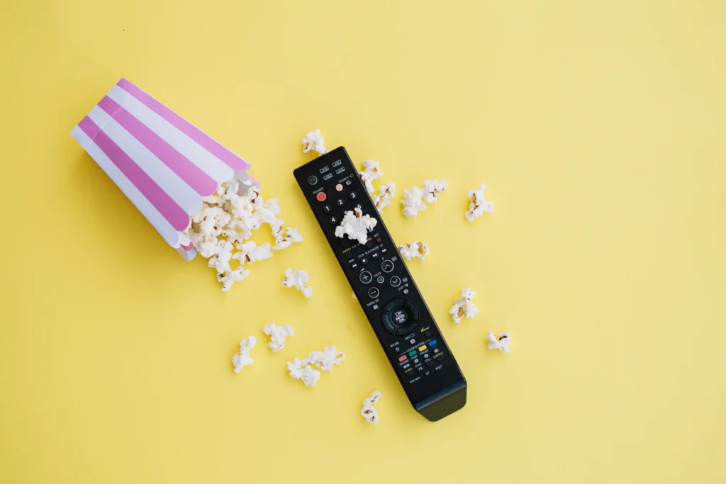 tv-remote-control-near-spilled-popcorn
